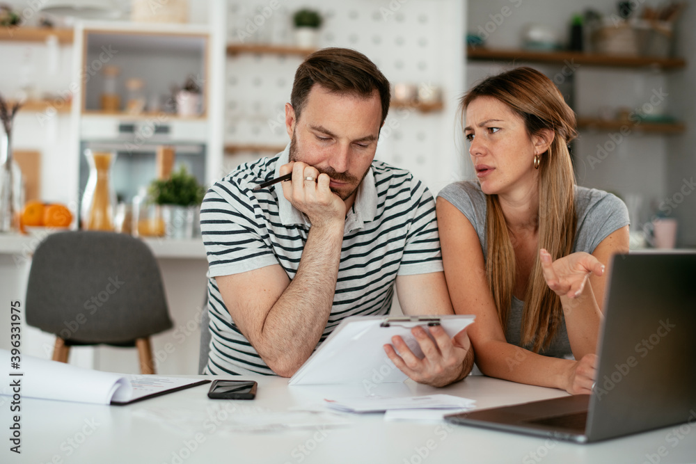 Husband and wife preparing bills to pay. Young couple having financial problems. Husband and wife preparing bills to pay. Young couple having financial problems.