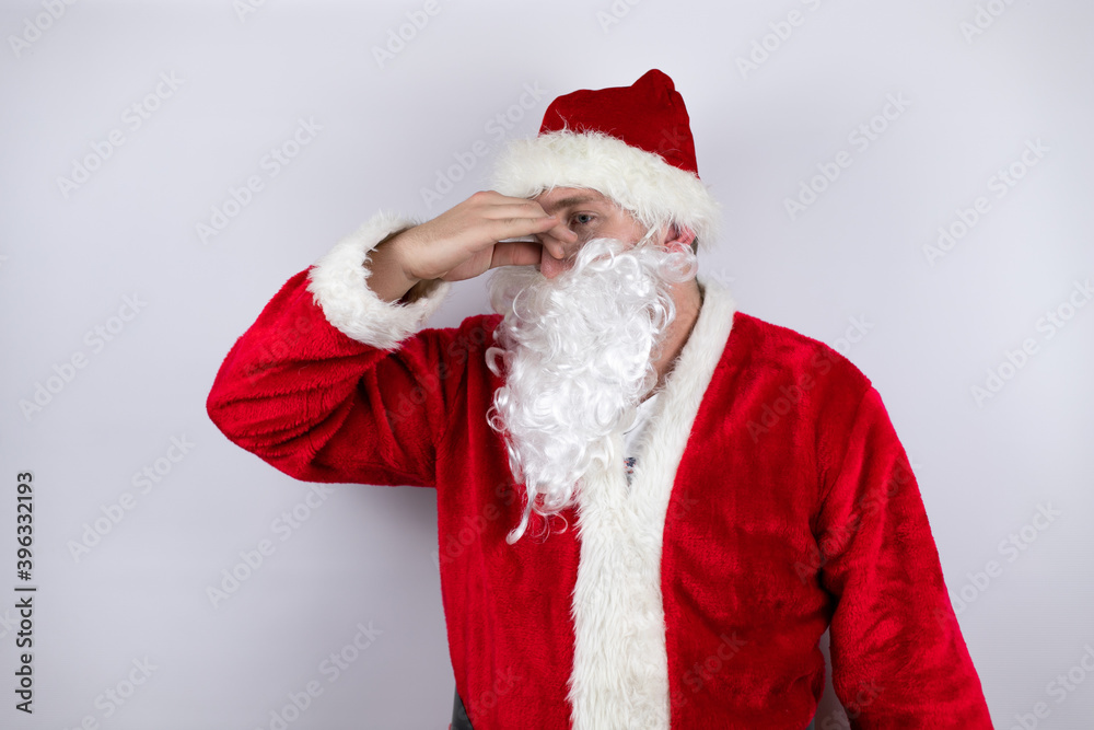 Man dressed as Santa Claus standing over isolated white background