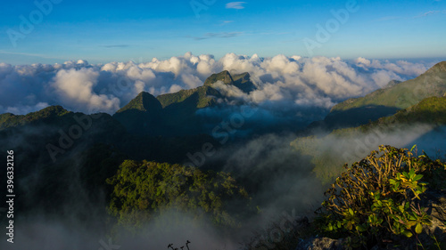 Morning sunrise with fog on top of mountain blue sky vacation trekking winter