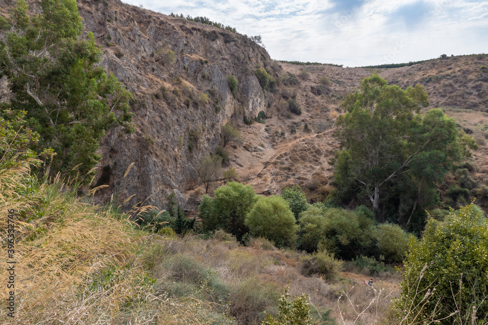 Hills overgrown  with greenery near the HaTanur waterfall, which is located in the continuation of the rapid, shallow, cold mountain Ayun river in the Galilee in northern Israel