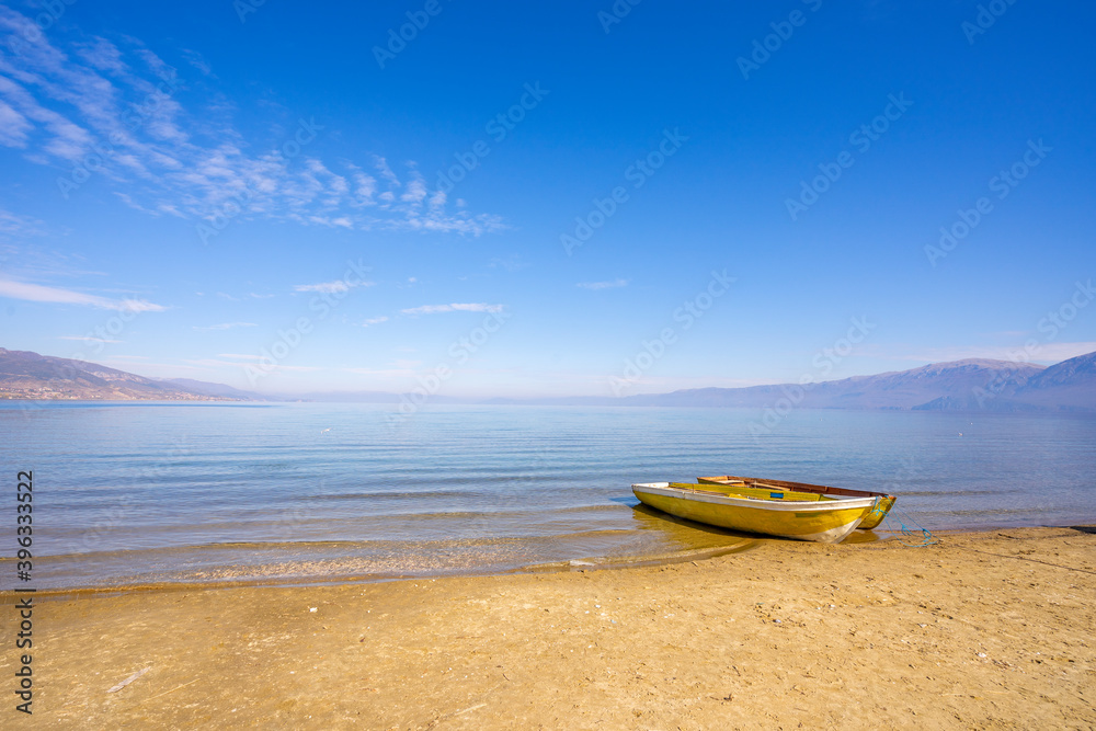 Wooden boats at pier on mountain lake