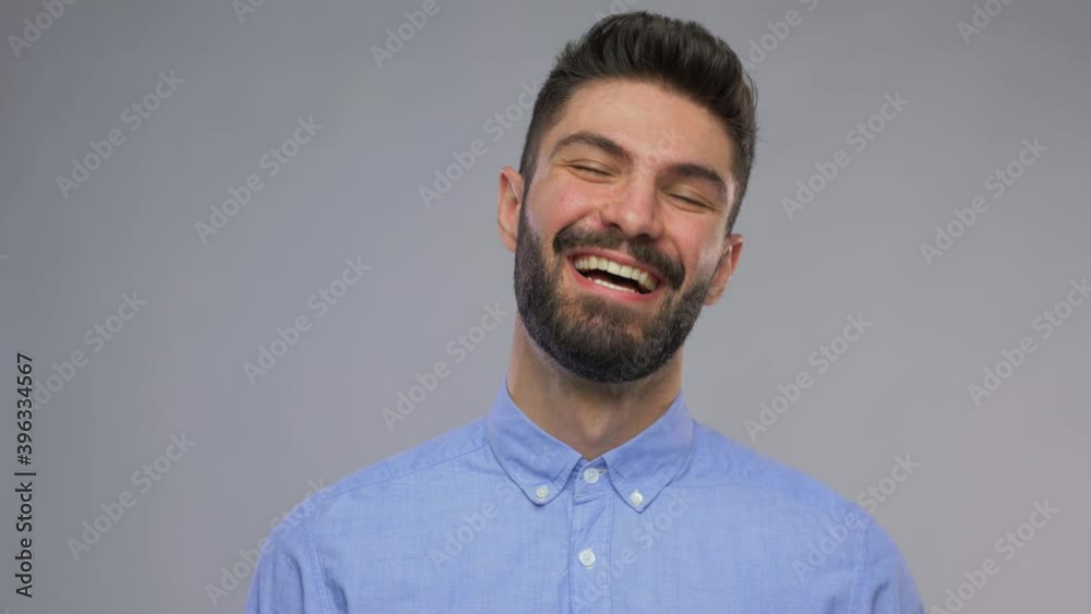 people and emotions concept - video portrait of happy smiling young man with beard over grey background people and emotions concept - video portrait of happy smiling young man with beard over grey background
