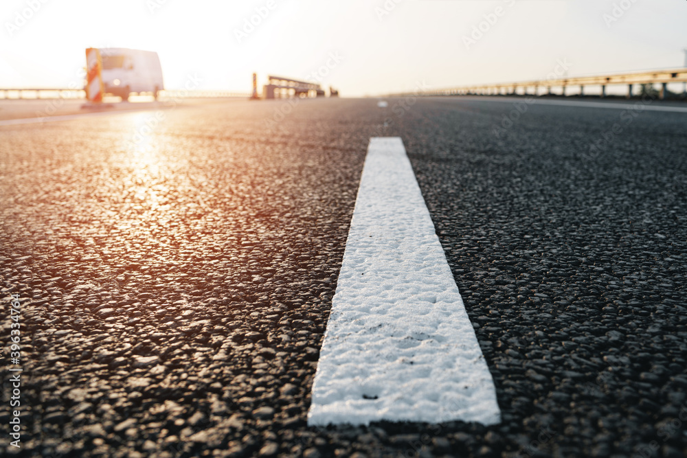 White marking line on asphalt road on highway
