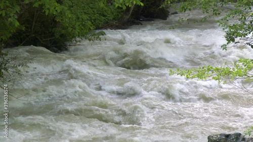 An Incredibly Fast Flowing Raging Foamy River in Spring Forest with Slow Motion.Amazon nile yangtze mississippi missouri yenisei ob irtysh forest parana plata congo chambeshi amur argun lena mekong 4K photo