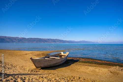 Wooden boat at pier on mountain lake