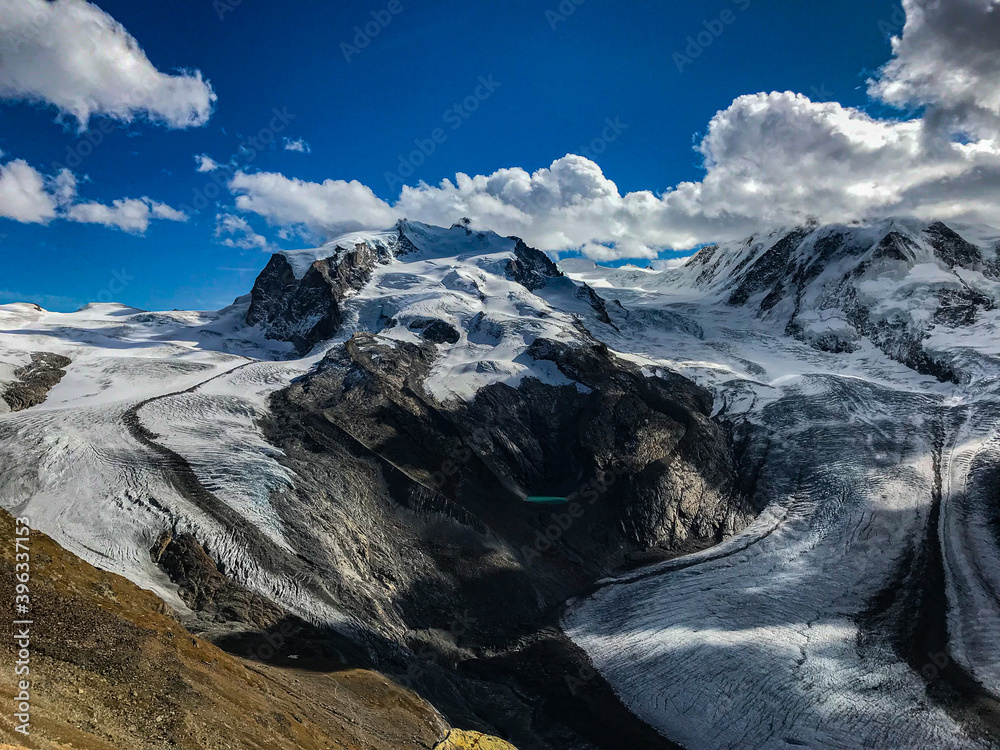 Obraz premium Sunny day with blue sky in the mountains of Switzerland with fantastic views of the Gorner glacier. Location of the Swiss Alps. The most famous tourist destination.