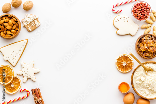 Flat lay of Christmas cooking with icing gingerbread cookies, top view