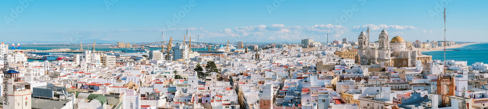 Aerial panoramic view of the old city rooftops and Cathedral de Santa Cruz in the afternoon from tower Tavira in Cadiz, Andalusia, Spain