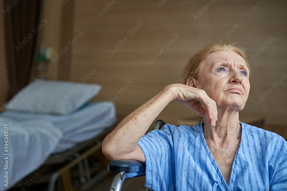 Grandma patient sitting on wheelchar in hospital room , lonely scence Grandma patient sitting on wheelchar in hospital room , lonely scence