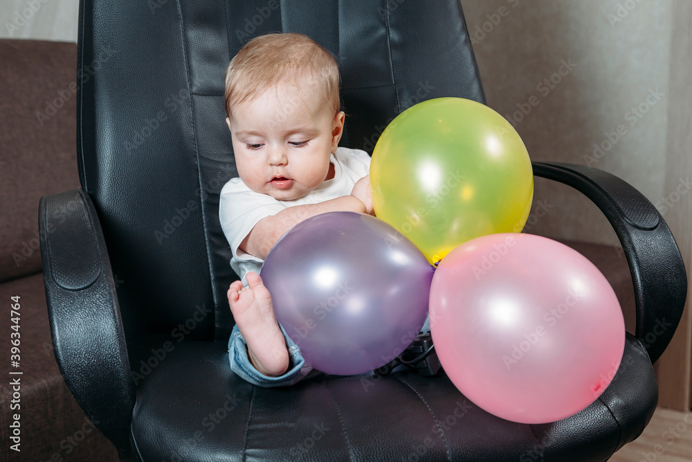 funny child sitting on chair little girl having fun playing big colorful balloons funny child sitting on chair little girl having fun playing big colorful balloons