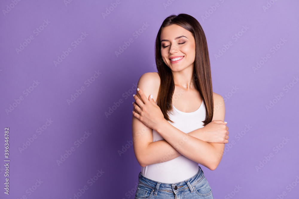 Photo of adorable smiling young woman wear casual white outfit embrace herself closed eyes isolated violet color background