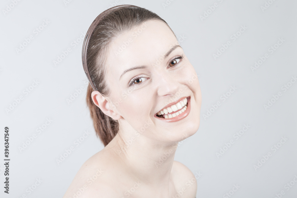 young woman shows positive emotional expressions and gives a big smile young woman shows positive emotional expressions and gives a big smile