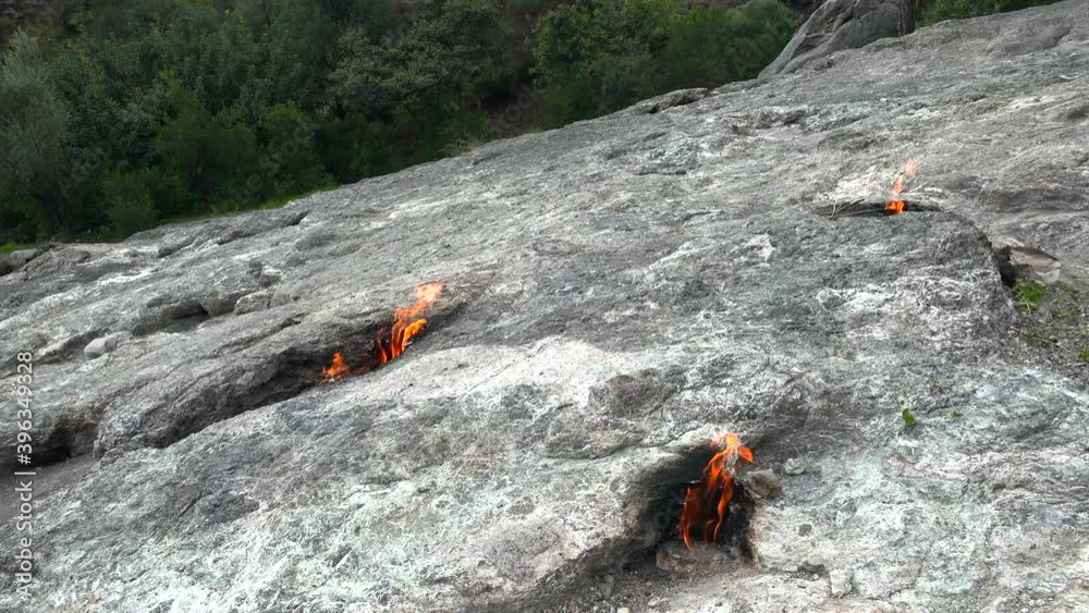 Flame of Methane Underground Emerges From Crack Between Rocks and Burns to Earth.Energy fire flames floor gas geological geology methane natural reserve rock source burn nature lava magma volcano 4K Flame of Methane Underground Emerges From Crack Between Rocks and Burns to Earth.Energy fire flames floor gas geological geology methane natural reserve rock source burn nature lava magma volcano 4K