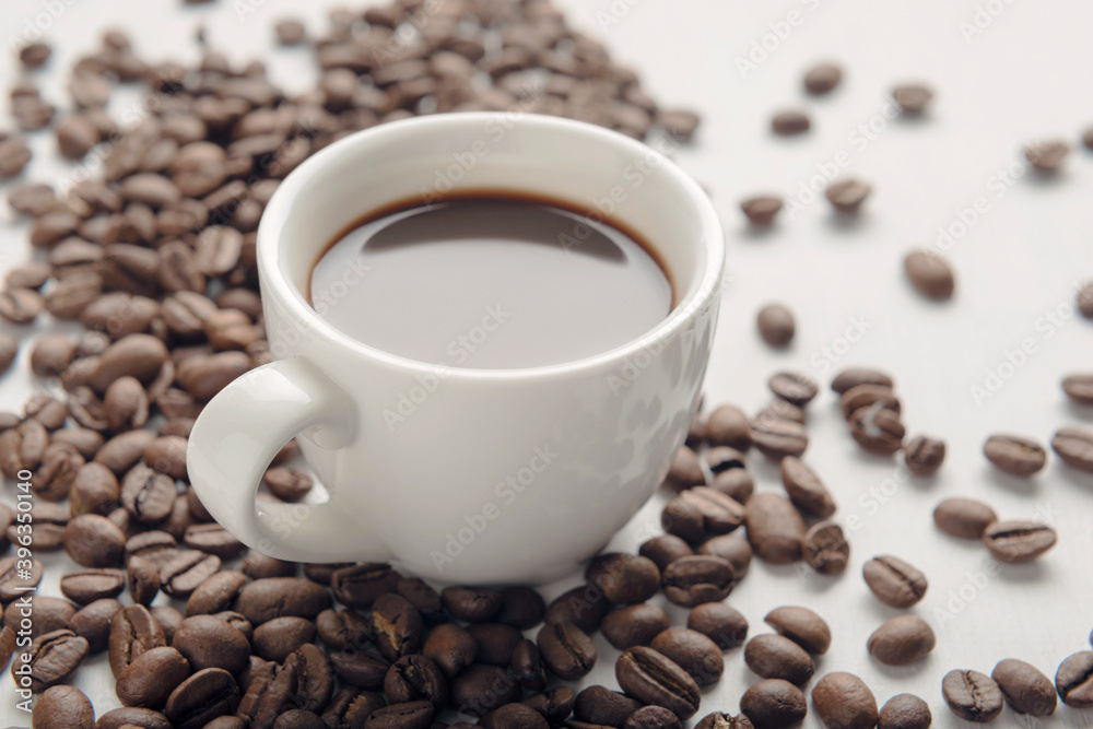 Cup of coffee with coffee beans on white background Cup of coffee with coffee beans on white background