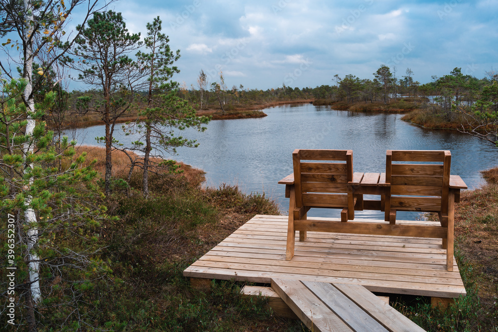 Top view of two wooden chairs by the lake of the Kemeri National Park Top view of two wooden chairs by the lake of the Kemeri National Park