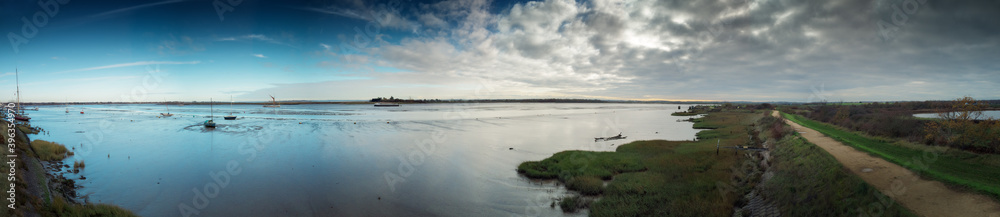 panoramic landscape image of mudflat in essex england