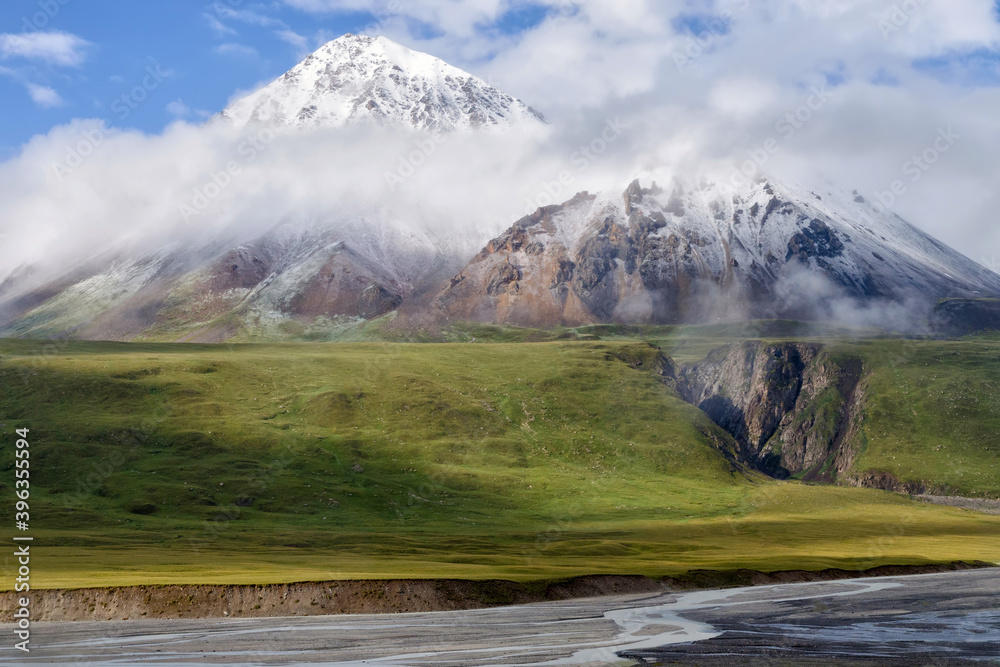 Mountain in the clouds, Saryjaz River Valley, Central Tian Shan, Kyrgyzstan. Mountain in the clouds, Saryjaz River Valley, Central Tian Shan, Kyrgyzstan.