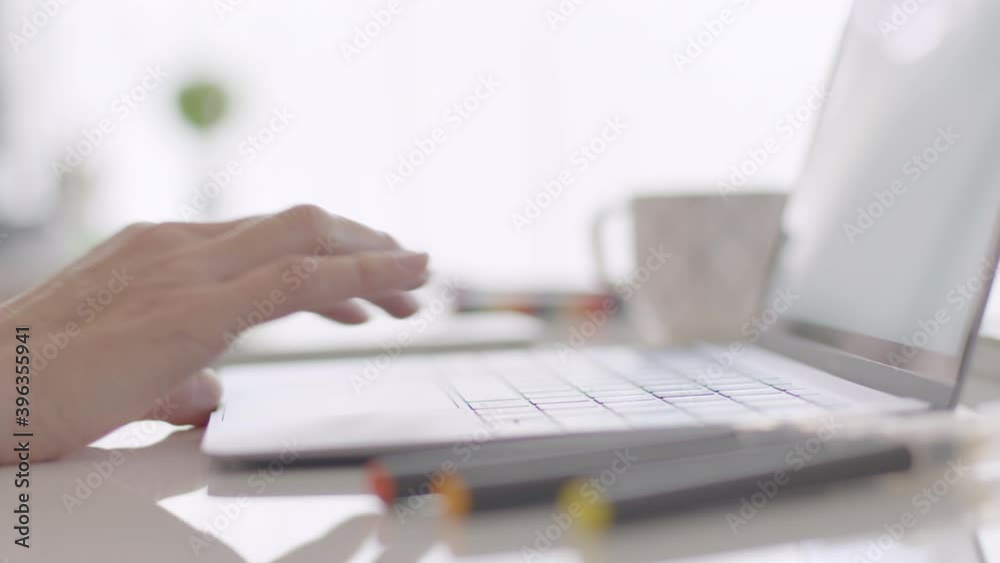 Female hands typing and scrolling on a track pad. Laptop. Detail shot. Shallow depth of field. Lateral dolly. Female hands typing and scrolling on a track pad. Laptop. Detail shot. Shallow depth of field. Lateral dolly.