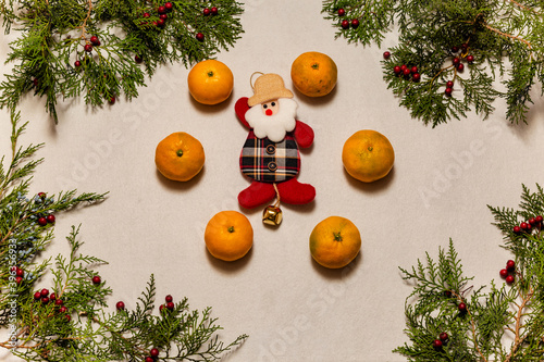 Christmas decoration with lots of tangerines and little santa in the center