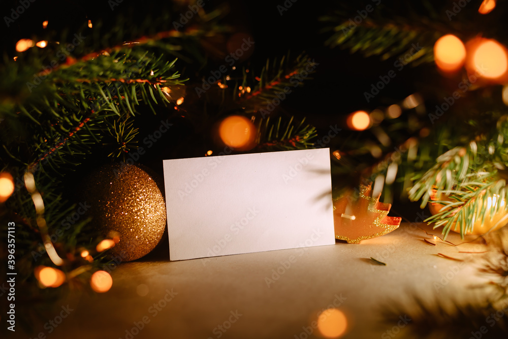 Blank business card with christmas tree branches and golden garland ...