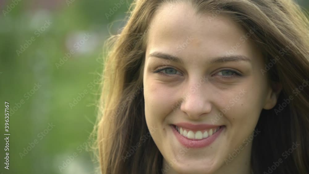 Beautiful girl with a smile on the background of the city Beautiful girl with a smile on the background of the city
