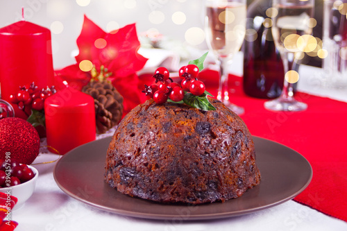 Traditional Christmas pudding with holly on top.