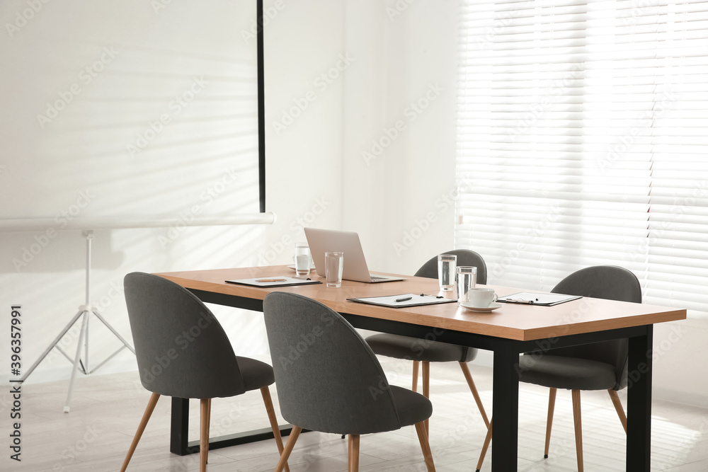 Fototapeta premium Conference room interior with wooden table and video projection screen