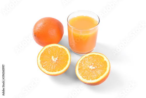 Orange juice in glass with oranges on white background