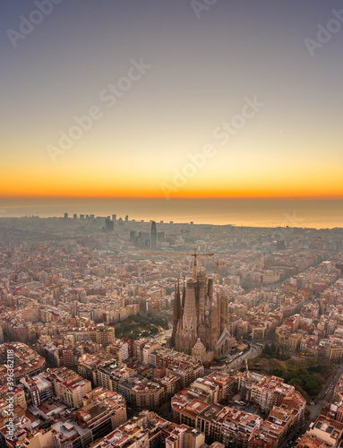 Aerial drone shot of Barcelona city before sunrise golden hour © Davidzfr