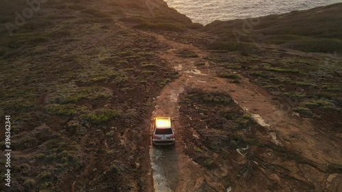 Drone Pan Up Shot of Offraoding SUV at Sunrise Hawaii