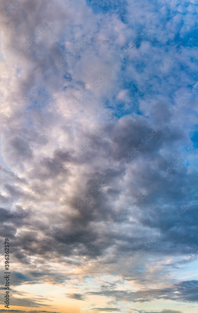 Fantastic clouds at sunrise, vertical panorama