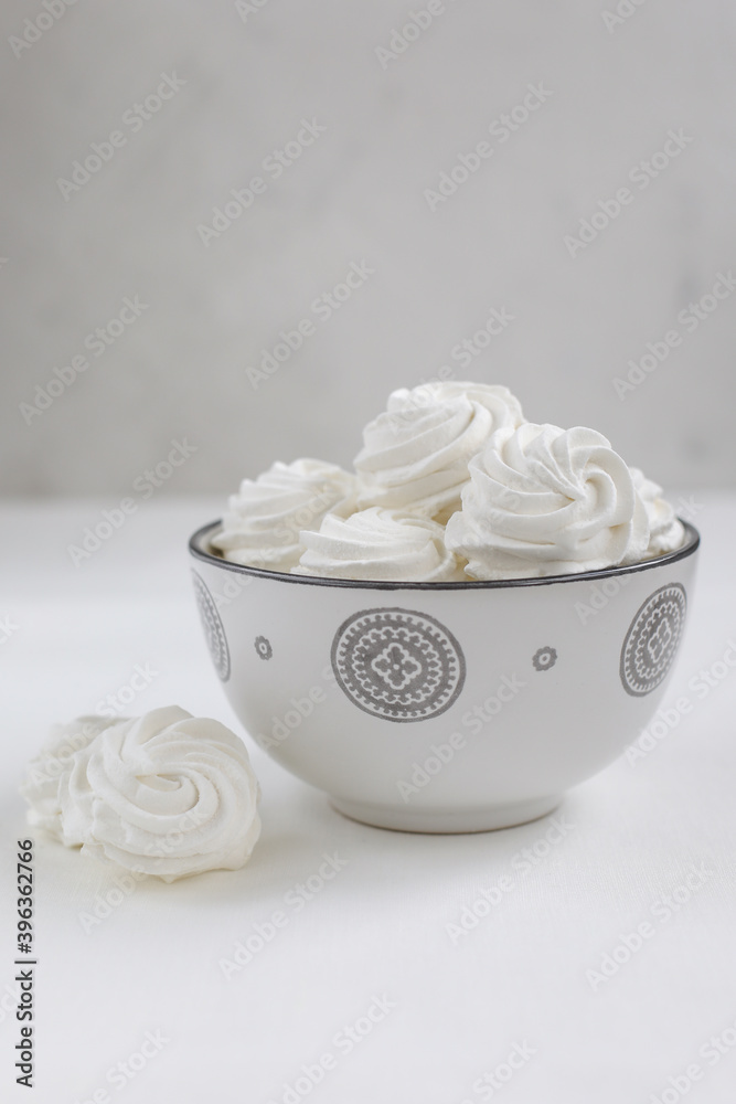 Fresh airy handmade vanilla marshmallows in a vase against a light background Fresh airy handmade vanilla marshmallows in a vase against a light background