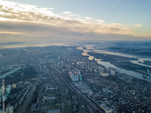 Aerial high flight over Kiev  haze over the city. Autumn morning  the Dnieper River is visible on the horizon.