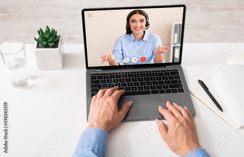 Business Lady Using Laptop Talking With Remote Colleague In Office