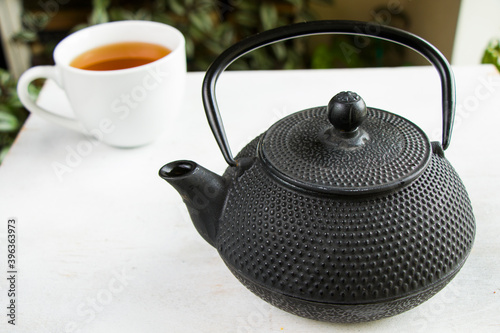 Herbal tea, iron teapot and cup, chinese traditional tea serving