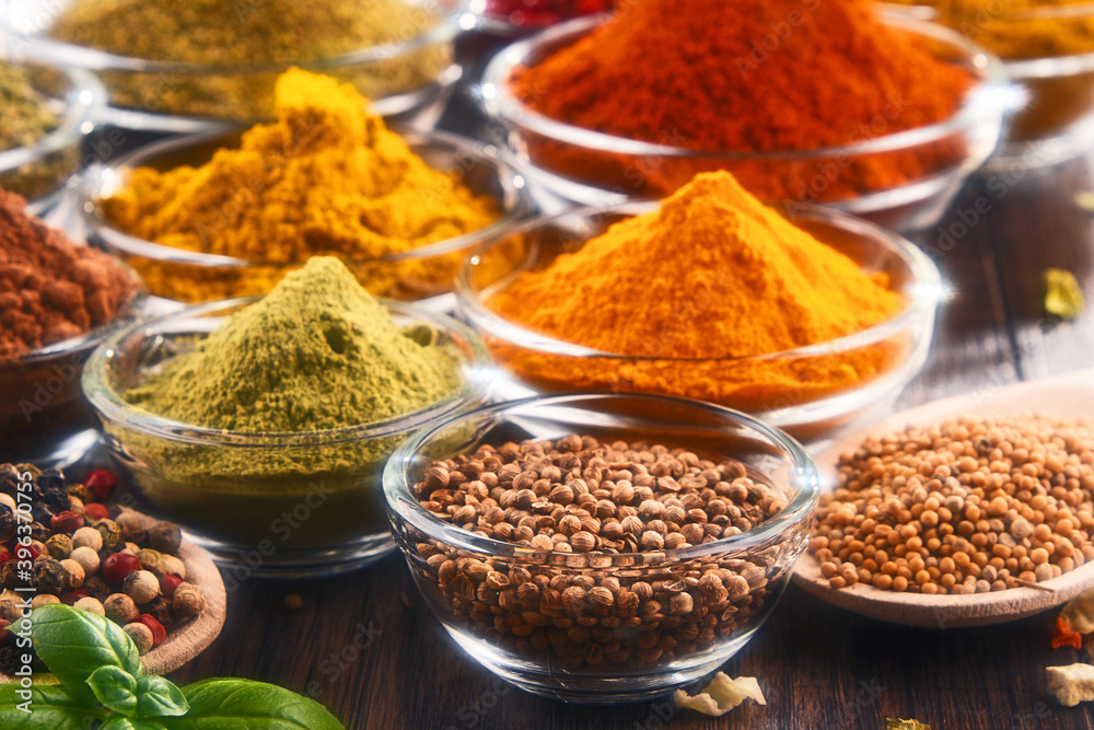 Variety of spices and herbs on kitchen table Variety of spices and herbs on kitchen table