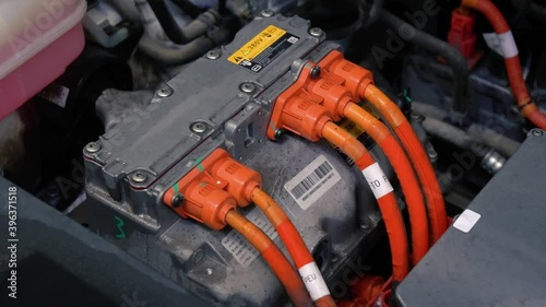 Close up detailed view of electric car engine in factory. Electric equipment of the a Japanese manufactured showing in a car showroom. Diagnostics and repair original spare parts. Saving the planet