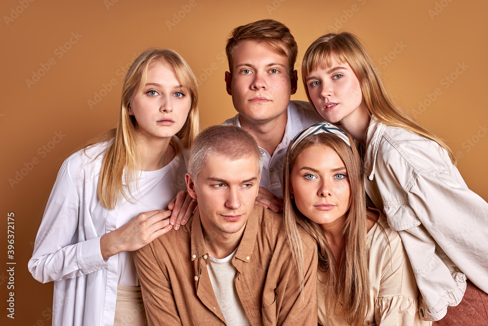 unusual group of extraordinary youth posing in trendy wear, caucasian models confidently look at camera isolated in studio unusual group of extraordinary youth posing in trendy wear, caucasian models confidently look at camera isolated in studio