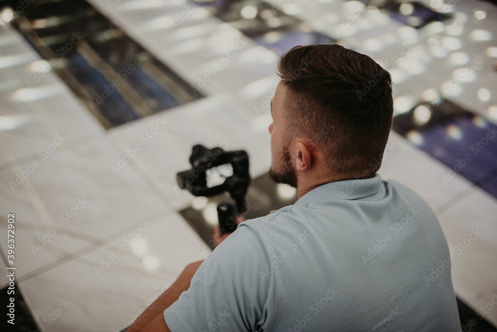 Video camera operator working with his equipment at indoor event. Video camera operator working with his equipment at indoor event.