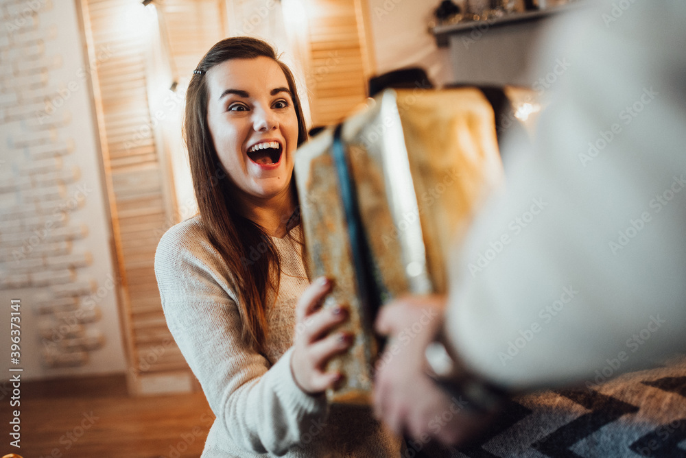 a guy and a girl celebrate the new year together. and give each other gifts a guy and a girl celebrate the new year together. and give each other gifts