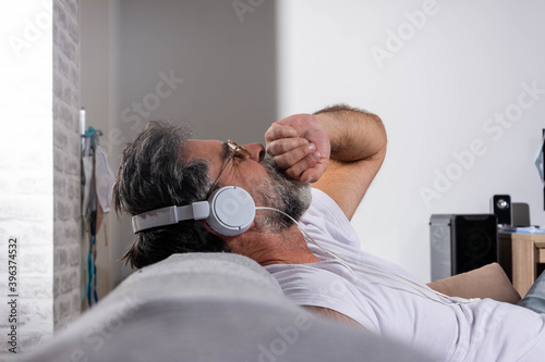 Cropped shot of a handsome mature man relaxing at home with some tunes. Let the music flow through you