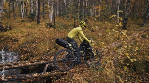 The woman travel on mixed terrain cycle touring with bikepacking. The traveler journey with bicycle bags. Sport tourism bikepacking.