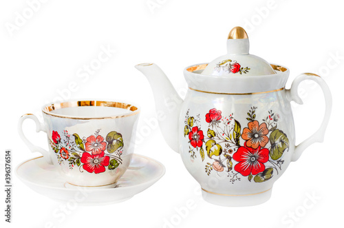 porcelain Cup with floral pattern on the saucer and teapot isolated on a white background