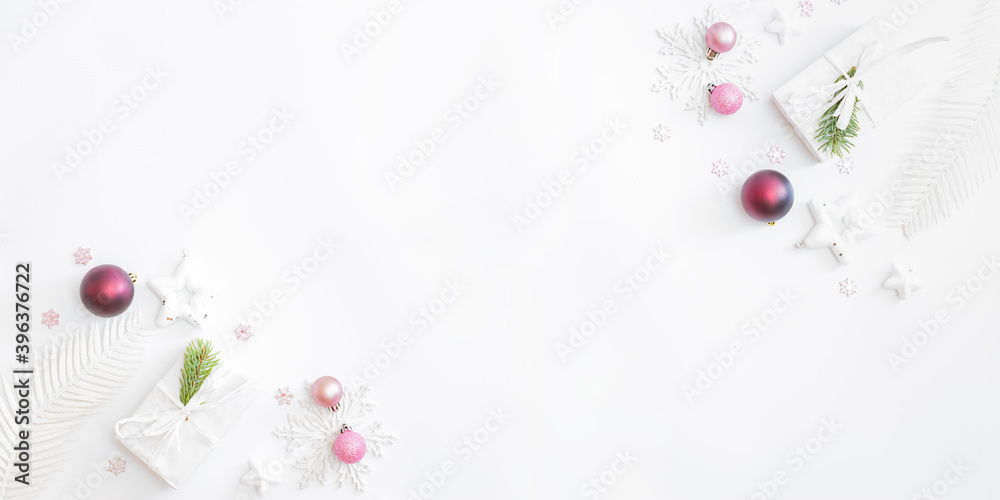 Flat lay frame with christmas balls, stars and gift box on a white background Flat lay frame with christmas balls, stars and gift box on a white background