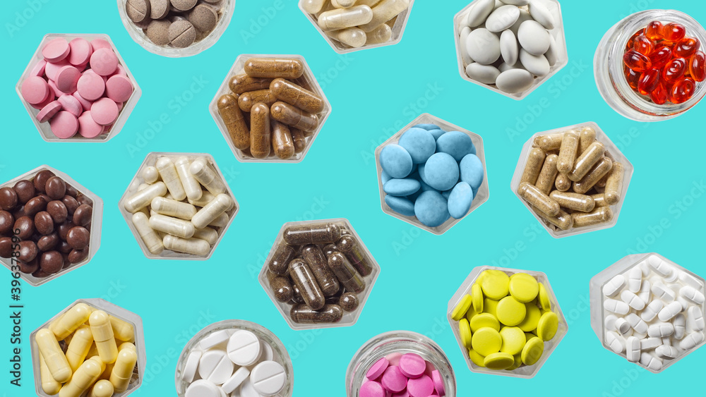 Medical capsules and pills in hexagonal jars on blue background Medical capsules and pills in hexagonal jars on blue background