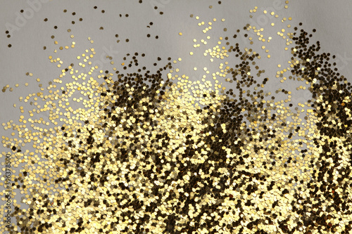 Gold (bronze) glitter shine dots confetti. Abstract light blink sparkle backgound.