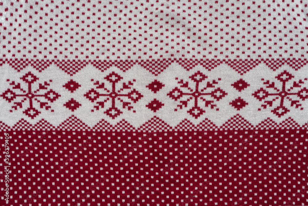 Norwegian Pattern Of Red And White Yarn. Fair Isle Ornament At Cozy Knitted Cloth. Wallpaper. Yarn Knitted Background. Norwegian Pattern Of Red And White Yarn. Fair Isle Ornament At Cozy Knitted Cloth. Wallpaper. Yarn Knitted Background.