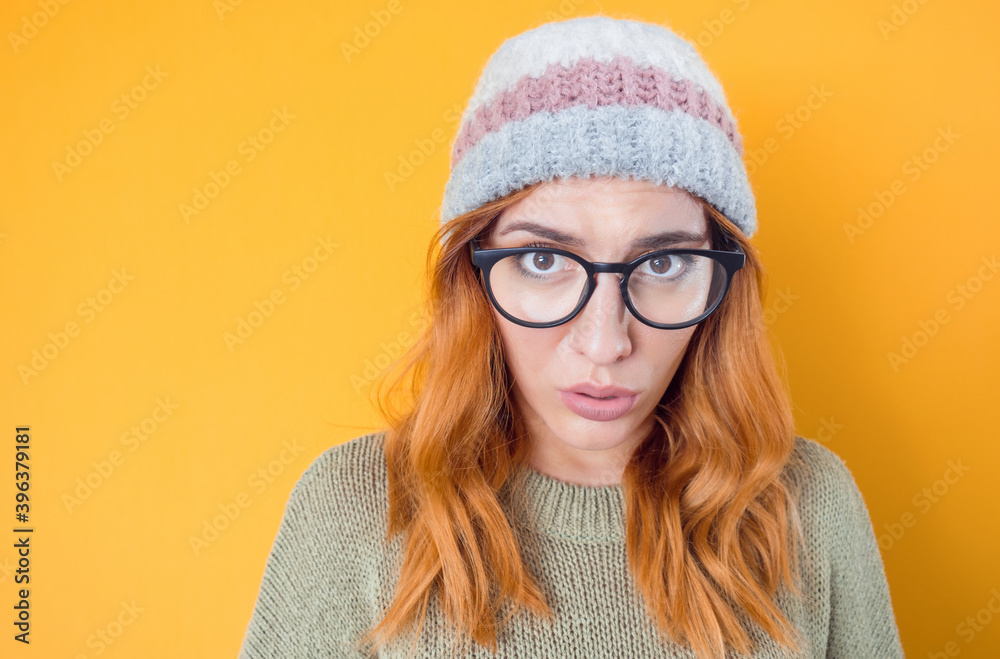 Impressed young woman looking at camera and say what, isolated on yellow background Impressed young woman looking at camera and say what, isolated on yellow background