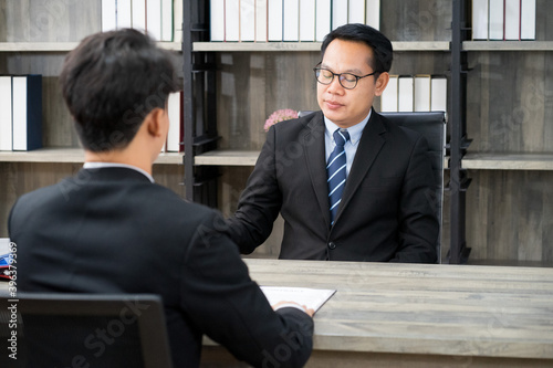 businessman wearing formal suit interviewing new candidate for new employment position in the financial office. new normal work from home concept. 