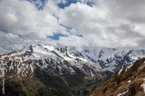 High in the Alps. Snow-capped mountain slopes. Low clouds in the lowlands of the forest.